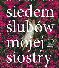 Okładka książki na której widać kobiętę leżącą wśród kwiatów.