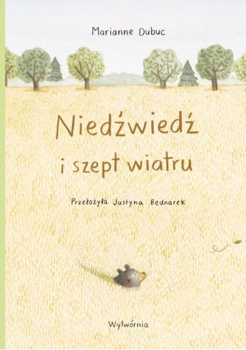 Jasna okładka w oddali drzewa i wychodząca z piasku głowa niedźwiedzia